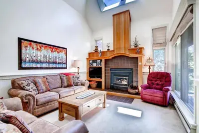 a living room with a couch and a fireplace at Soda Springs 1 Bedroom Townhome in Keystone