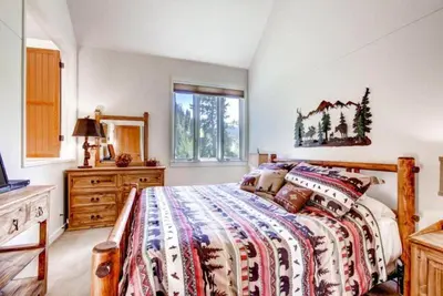a bedroom with a bed and a dresser and a window at Soda Springs 1 Bedroom Townhome in Keystone
