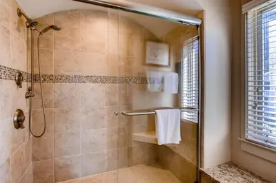 a bathroom with a shower with a glass door at Soda Springs 3 Bedroom Townhome in Keystone