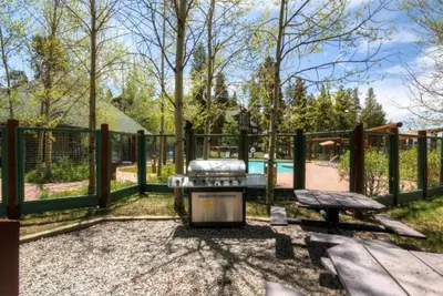 a backyard with a picnic table and a fence at Soda Springs 3 Bedroom Townhome in Keystone