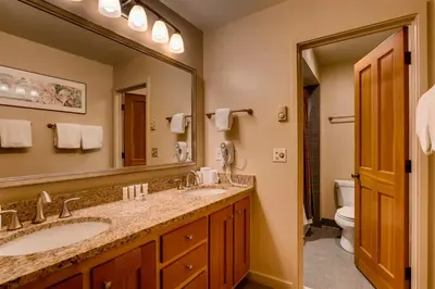 a bathroom with two sinks and a large mirror at Soda Springs 3 Bedroom Townhome in Keystone