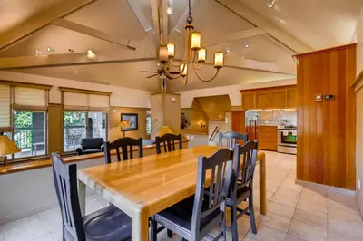 a dining room and kitchen with a wooden table and chairs at Soda Springs 3 Bedroom Townhome in Keystone