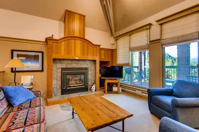 a living room with a couch and a fireplace at Soda Springs 3 Bedroom Townhome in Keystone