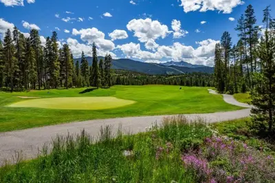 a golf course with a road leading to a green at 1 Bedroom Condo In Keystone - West Keystone in Keystone