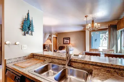 a kitchen with a sink and a christmas tree on the wall at 1 Bedroom Condo In Keystone - West Keystone in Keystone