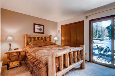 a bedroom with a bed and a sliding glass door at 1 Bedroom Condo In Keystone - West Keystone in Keystone