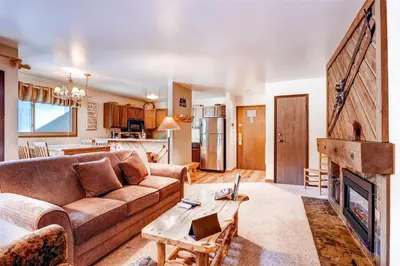 a living room with a couch and a fireplace at 1 Bedroom Condo In Keystone - West Keystone in Keystone