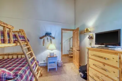 a bedroom with a bunk bed and a tv and a bunk bedskirts at 2 Bedroom Condo In Keystone - West Keystone in Keystone