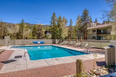 a swimming pool in a yard with a house at 2 Bedroom Condo In Keystone - West Keystone in Keystone