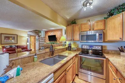 a kitchen with a sink and a stove top oven at 2 Bedroom Condo In Keystone - West Keystone in Keystone