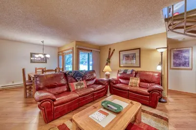 a living room with leather couches and a table at 2 Bedroom Condo In Keystone - West Keystone in Keystone