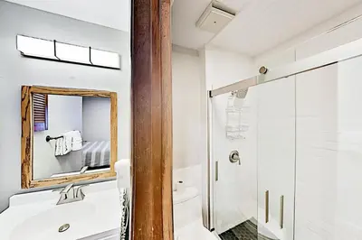 a bathroom with a shower and a sink and a mirror at 3 Bedroom Condo In Keystone - West Keystone in Keystone