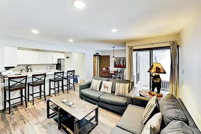 a living room with a couch and a kitchen at 3 Bedroom Condo In Keystone - West Keystone in Keystone