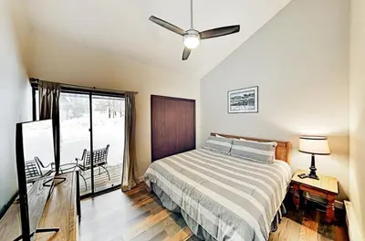 a bedroom with a bed with a ceiling fan at 3 Bedroom Condo In Keystone - West Keystone in Keystone