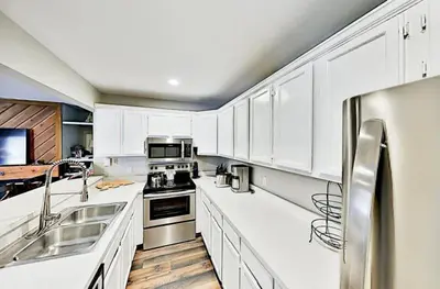 a large white kitchen with white cabinets and appliances at 3 Bedroom Condo In Keystone - West Keystone in Keystone