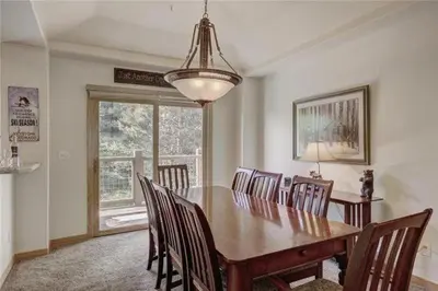 a dining room with a wooden table and chairs at Northstar Townhomes In Keystone 2 Bedroom Rental in Keystone