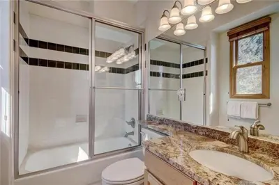 a bathroom with a shower and a toilet and a sink at Northstar Townhomes In Keystone 2 Bedroom Rental in Keystone