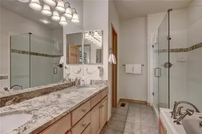 a large bathroom with two sinks and a shower at Northstar Townhomes In Keystone 2 Bedroom Rental in Keystone