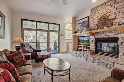 a living room with a couch and a fireplace at Northstar Townhomes In Keystone 2 Bedroom Rental in Keystone