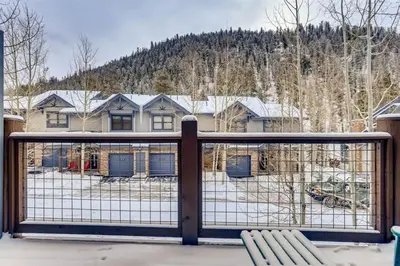 a balcony with a gate with a snow covered yard at Northstar Townhomes In Keystone 2 Bedroom Rental in Keystone