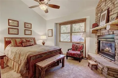 a bedroom with a bed and a fireplace at Northstar Townhomes In Keystone 2 Bedroom Rental in Keystone