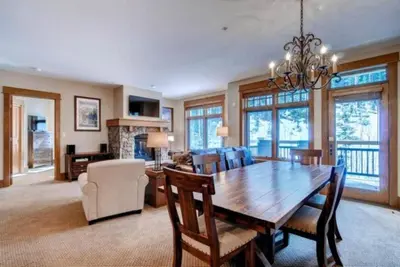 a dining room with a wooden table and chairs at The Timbers In River Run 2 Bedroom Condo in Dillon