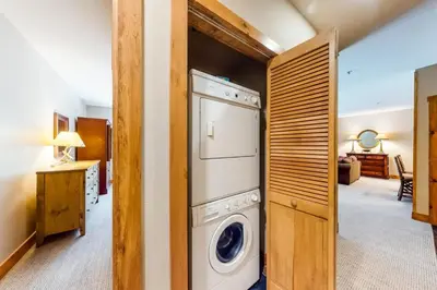 a laundry room with a washer and dryer at 2 Bedroom Ski-In, Ski-Out Condo At The Timbers in Keystone