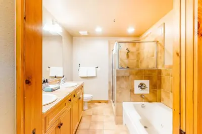 a bathroom with two sinks and a shower at 2 Bedroom Ski-In, Ski-Out Condo At The Timbers in Keystone