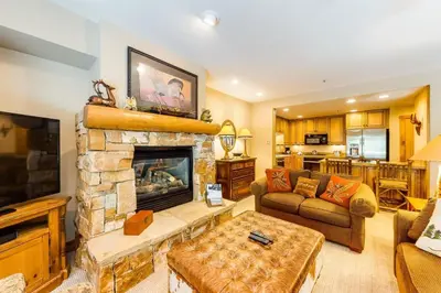 a living room with a couch and a fireplace at 2 Bedroom Ski-In, Ski-Out Condo At The Timbers in Keystone