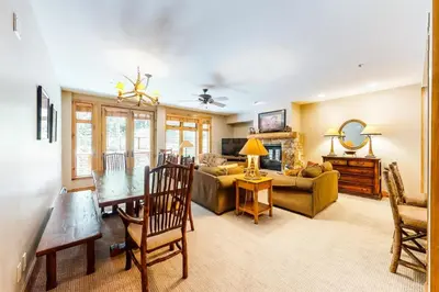 a living room with a table and a couch at 2 Bedroom Ski-In, Ski-Out Condo At The Timbers in Keystone