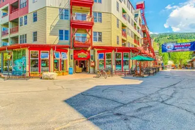 a large building with red trim on a city street at Silvermill Lodge 1 Bedroom In River Run Village in Keystone