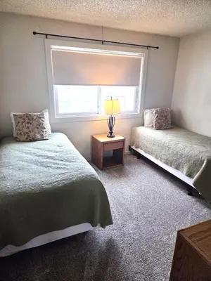 a bedroom with two beds and a window at Twin Rivers By Alderwood Colorado Management in Fraser