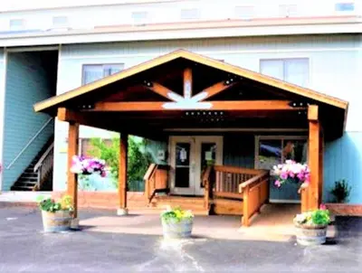 a covered porch of a house with potted plants at Twin Rivers By Alderwood Colorado Management in Fraser