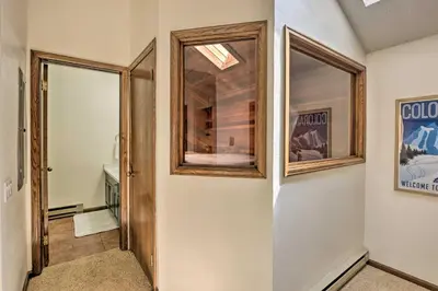 a hallway with a door and a window in a house at Mtn View Granby Condo with In-Unit Hot Tub! in Granby