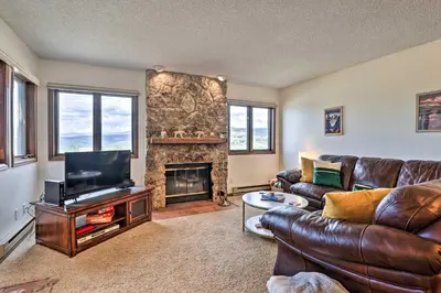 a living room with leather furniture and a fireplace at Mtn View Granby Condo with In-Unit Hot Tub! in Granby