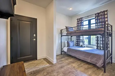 a bedroom with two bunk beds and a window at Hot Tub and Balcony Riverfront Silverthorne Condo! in Silverthorne