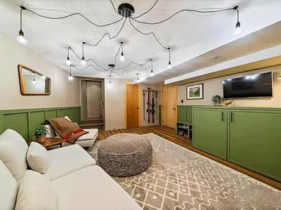 a living room with a couch and a tv at Classic Log Cabin near Rocky Mountain National Park and near Skiing in Lyons