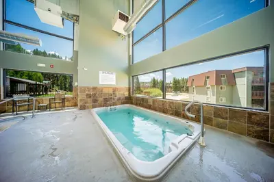 a large bath tub in a room with windows at Hi Country 11-13 in Winter Park