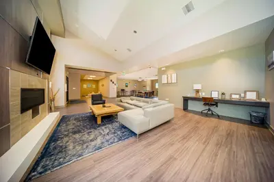 a living room with a white couch and a table at Hi Country 11-13 in Winter Park
