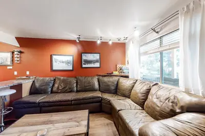 a living room with a brown leather couch at Hi Country 11-13 in Winter Park