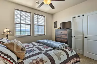a bedroom with a bed and a dresser and a television at Balcony and Grill Mtn-View Retreat in Granby! in Granby