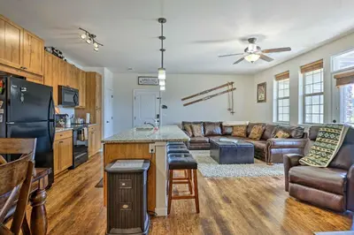 a kitchen and living room with a couch and a table at Balcony and Grill Mtn-View Retreat in Granby! in Granby