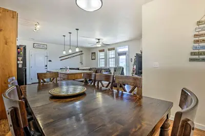 a dining room and kitchen with a wooden table and chairs at Balcony and Grill Mtn-View Retreat in Granby! in Granby
