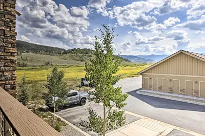 a car parked in a parking lot next to a building at Balcony and Grill Mtn-View Retreat in Granby! in Granby