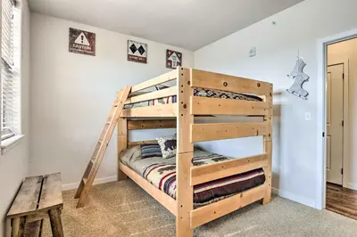 a wooden bunk bed in a room with a bench at Balcony and Grill Mtn-View Retreat in Granby! in Granby