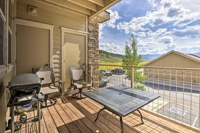 a patio with a grill and chairs on a balcony at Balcony and Grill Mtn-View Retreat in Granby! in Granby