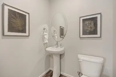 a bathroom with a sink and a mirror and a toilet at Modern Farmhouse Townhome - Great Central Location in Fort Collins