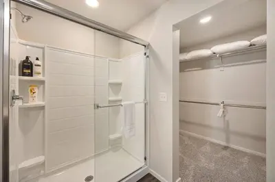 a walk in shower in a bathroom with a glass shower stall at Modern Farmhouse Townhome - Great Central Location in Fort Collins