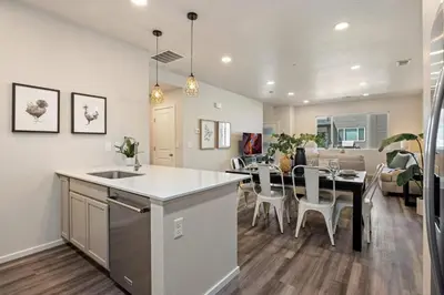 a kitchen and living room with a table and a dining room at Modern Farmhouse Townhome - Great Central Location in Fort Collins