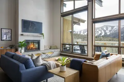 a living room with two couches and a fireplace at Mountain Home with Hot Tub, Near WP Resort! in Winter Park